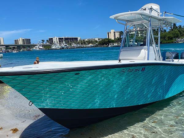 Vinyl wrap installation on a boat by Marine Wraps, offering a sleek, custom look.